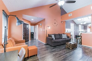 Relax in this inviting living space with a sofa set, coffee table, and floor lamp.