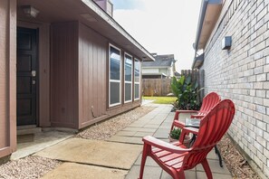 Enjoy outdoor dining or relaxation in the patio area with a chair and table.