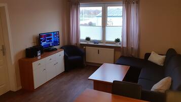 Apartment | Living area | 32-inch flat-screen TV with cable channels, TV, DVD player