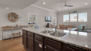 A spacious kitchen with granite countertops, a double sink, and dark wooden cabinets. - ⭐Walk to Beach and Restaurants-Gulf Views-Pool+Hot Tub-3BR Alerio C303⭐ (Miramar Beach)