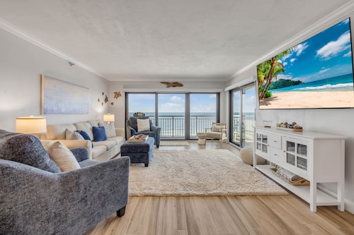 Top-floor direct oceanfront 2/2 with a private balcony, heated pool and beach access