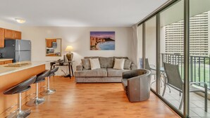 A modern apartment with a kitchen, dining area, and a balcony with a city view. - Deluxe Condo with Recreation Deck View, Free parking & WiFi (Honolulu)