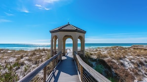 A wooden boardwalk leading to a gazebo with a tiled roof, overlooking a beach with sand dunes and the ocean. - Lake Views ~ Private Pool ~ Outdoor Lounge Area (Destin)
