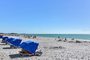 On the beach, sun loungers, beach towels