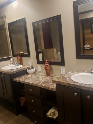 Bathtub, hair dryer, towels, toilet paper