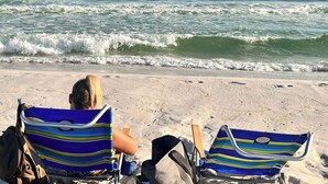 Two beach chairs on a sandy beach with the ocean in the background. - Heron 408 — 3BR Bayside Condo at Destin West with Heated Pool (Fort Walton Beach)