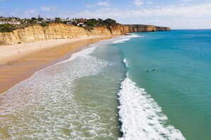 A coastal beach with a clear view of the ocean and a sandy shore. - Spacious modern apartment [104] (Lagos)