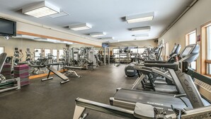 A gym with treadmills, weight machines, and a mirrored wall. - Lakeside 1476 (Keystone)