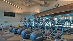 A gym with treadmills, elliptical machines, and stationary bikes. - Relaxing Home Pool Access and Screened-In Porch! (Sarasota)