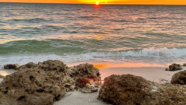 A beach with rocky formations and the ocean. - Coconut Castaway | Ocean Views, Golf Cart & Club Pool (Upper Captiva)