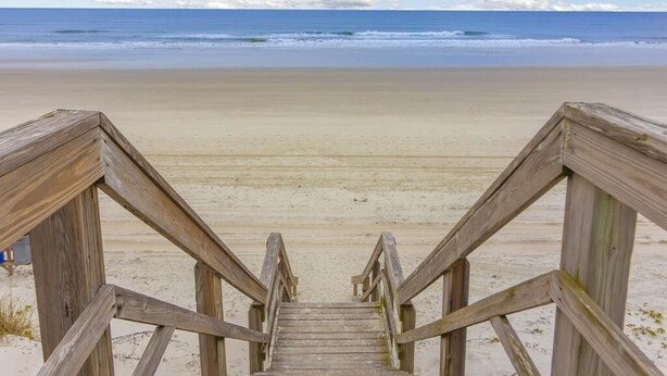 A wooden staircase leading to a beach with a clear view of the ocean. - Spacious Townhome ~ Pet Friendly ~ Great Beach Location! (Saint Augustine)