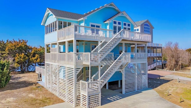 A multi-story beachfront house with balconies, a staircase, and a pool area. - Semi-Oceanfront Dog Friendly w/ Pool, Hot Tub, Game Room, Theater, Tiki Bar (Waves)
