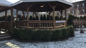 A gazebo with a sign indicating it is for B&B guests only, surrounded by snow-covered ground and trees.