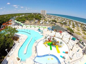 A resort with a large pool area, water slides, and a beach view. - Ocean Lakes Private SeaShed (Myrtle Beach)