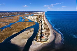 Guest accommodations line the beachfront, offering access to the adjacent shoreline.