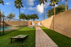 A backyard with a pool, a ping pong table, and a barbecue grill. - Perfect Location in Phoenix!! (Phoenix)