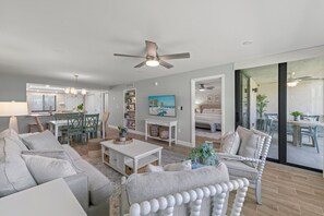 Relax in this stylish living area with a large sofa, coffee table, and armchair, perfect for unwinding and socializing.