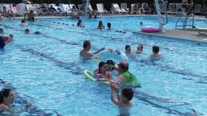 A swimming pool with multiple lanes, lounge chairs, and umbrellas. - Masthope  Community Charming Chalet 3 day min stay.  (Lackawaxen)
