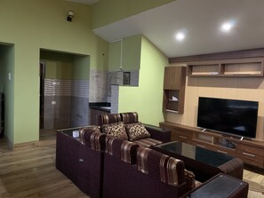 Elite Apartment | Living area | 55-inch LED TV with digital channels, TV - 2BHK Apartment with Fast Internet (Siddharthanagar)
