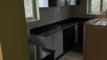 Elite Apartment | Private kitchen | Fridge, cookware/dishes/utensils, cleaning supplies, paper towels