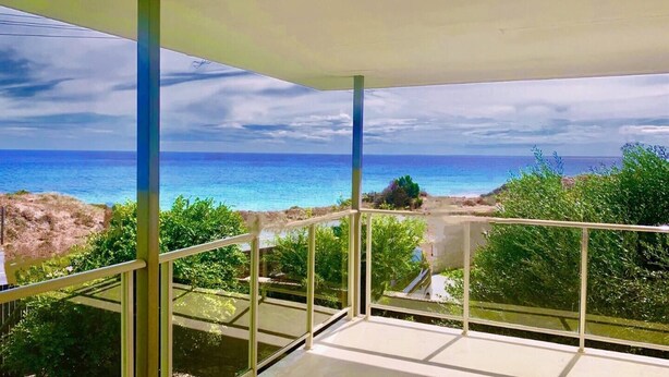 A balcony with a clear view of the ocean and surrounding greenery. - Beach Home: Epic Views: Private Enclosed Yard:Pets (Halls Head)