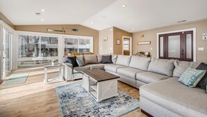 A spacious living room with a large sectional sofa, a coffee table, and a patterned rug. - Timeless Memories by SoCharm | Amazing Views & Guest Suite!| Dock & Firepit (Mooresville)
