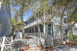 A two-story house with a porch, a white picket fence, and a mailbox. - Charming Charleston-Style Beach Home in Seaside; Sleeps 10; Near Beach & Pool (Santa Rosa Beach)