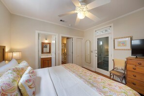 A bedroom with a bed, a ceiling fan, a dresser, a chair, and a television. - Charming Charleston-Style Beach Home in Seaside; Sleeps 10; Near Beach & Pool (Santa Rosa Beach)