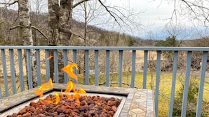 A stone fire pit with burning embers on a deck. - ★Views★Golf Cart Included★Behind Resort Gate★Member Areas Included (Lake Lure)