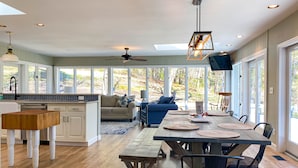 A spacious kitchen with a dining area, large windows, and a ceiling fan. - ★Views★Golf Cart Included★Behind Resort Gate★Member Areas Included (Lake Lure)