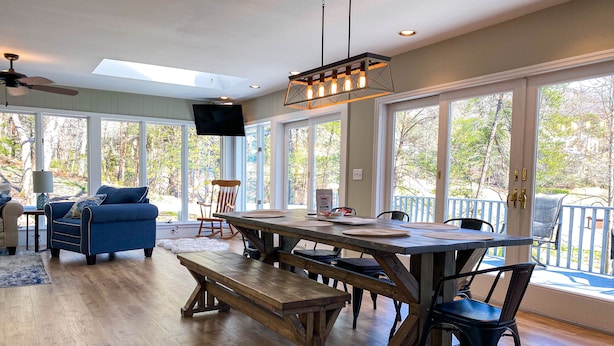 A spacious living area with a wooden dining table, benches, and a blue sofa. - ★Views★Golf Cart Included★Behind Resort Gate★Member Areas Included (Lake Lure)