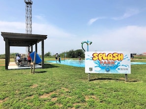 A park with a swimming pool, a covered seating area, and a sign for Splash Park. - Sunset Sanctuary - Yep, Coolest Sunrises & Sunsets Here! (Surfside Beach)