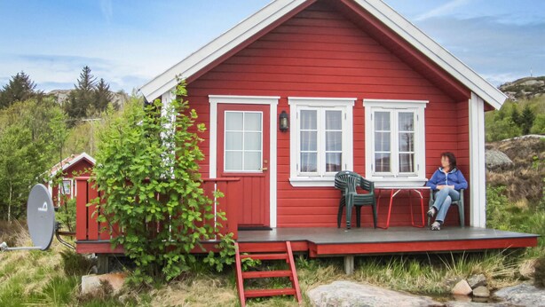 A red cabin with a porch, a ladder, and a chair. - Awesome home in Spangereid with kitchen (Spangereid)