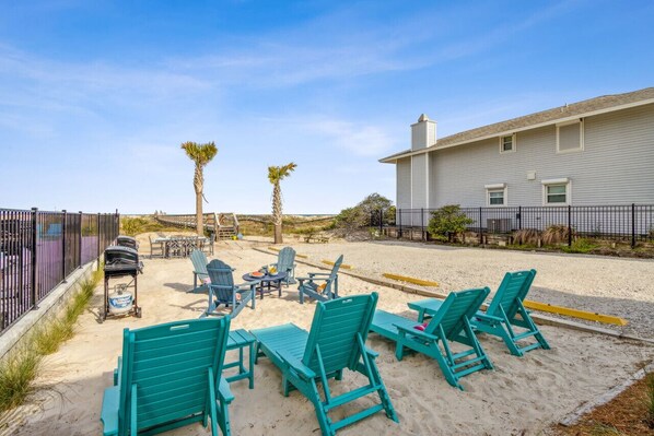 A beachside patio with outdoor seating and a barbecue grill. - Flamingo Loft | Charming Oceanfront Loft | Multiple Decks | Private Beach Access (Fernandina Beach)