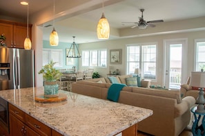 Enjoy meal preparation and socializing in this spacious kitchen and living area with a central island.