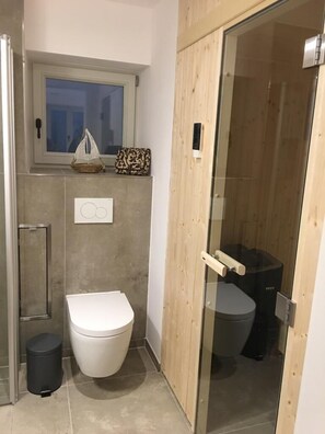 Shower, hair dryer, towels, toilet paper