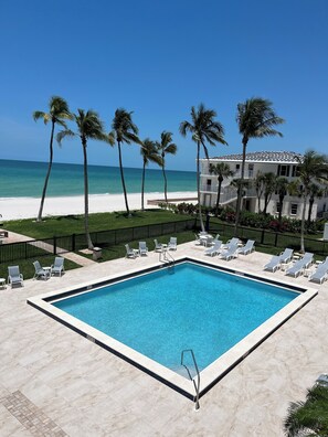 Outdoor pool, a heated pool - Beachfront Vanderbilt Beach Condo in Naples, FL (Naples)