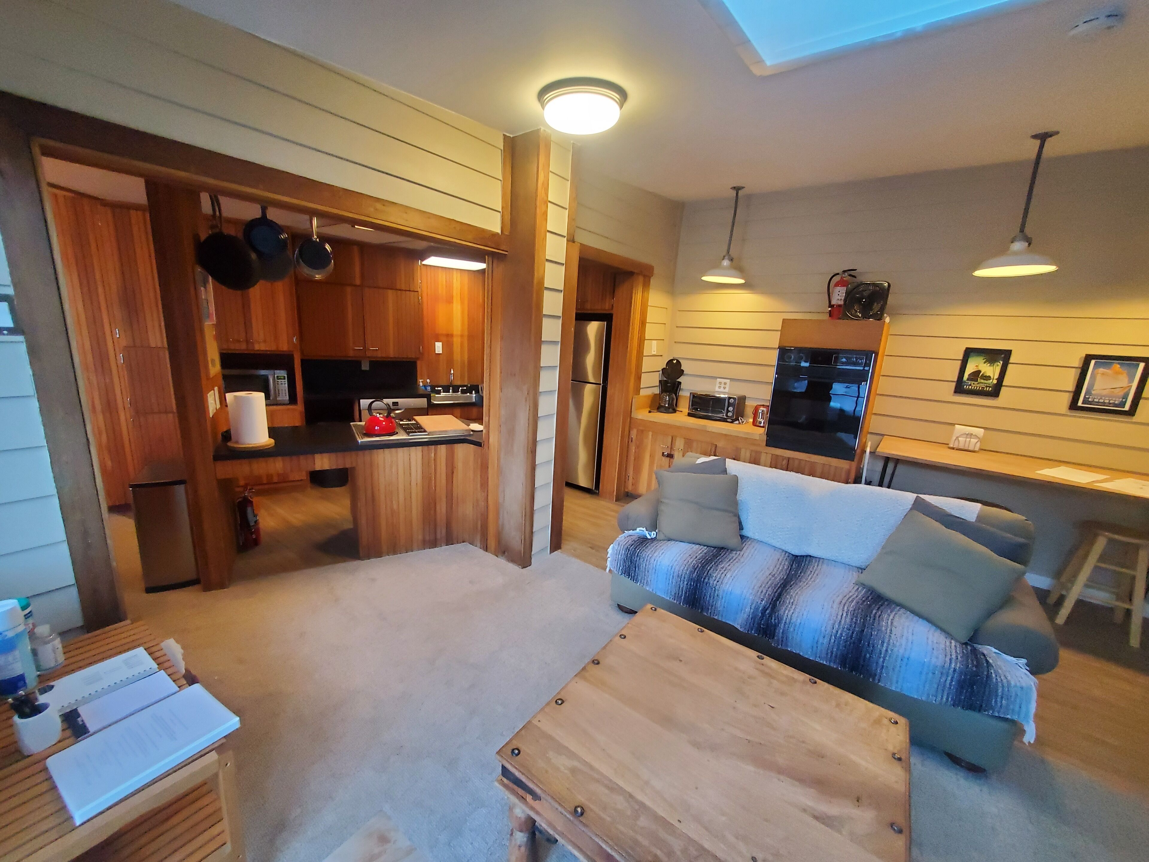 A compact living space with a kitchenette, a sofa, and a dining area.