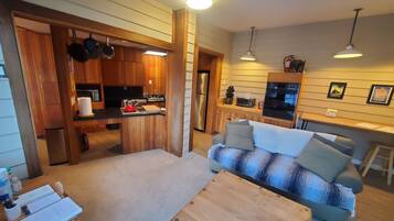 A compact living space with a kitchenette, a sofa, and a dining area.