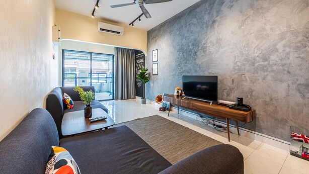 A modern living room with a sofa, TV, and a ceiling fan. - Conceptual Homestay 3BR 9PAX (Ampang)