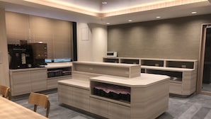 A modern kitchen with built-in appliances, a dining area, and a seating area.