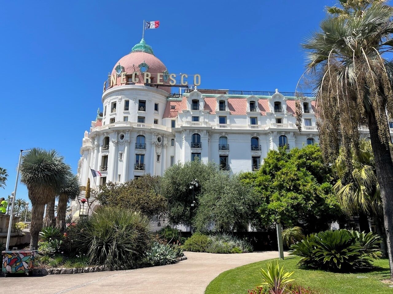 A large, historic building with a prominent dome and the name 'NUEVOS COLOMBIA' on the facade.