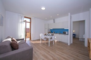 Family Apartment, Multiple Bedrooms (Appartamento Blu) | Living area | 21-inch flat-screen TV with digital channels, TV