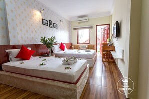 A hotel room with two beds, a TV, a small table, and a window. - The Queen Hotel and Spa (Hanoi)