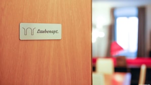 A wooden door with a sign that reads "Laubenapt." - "Lauben Uno" New apartment with modern design, in the center of Merano! (Merano)