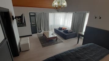 Standard Triple Room | Living area | 55-inch LCD TV with satellite channels, TV