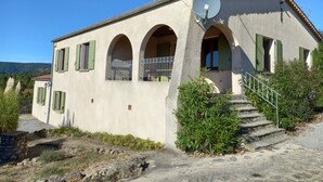 Ein Gebäude mit Satellitenschüssel, Rundbogenfenstern und einer Treppe zum Eingang.