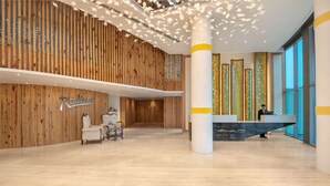 A spacious lobby with a wooden wall, a reception desk, and a chair. - Radisson Hotel Bareilly Airport (Bareilly)