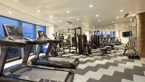 A gym with treadmills, weight machines, and exercise balls. - Radisson Hotel Bareilly Airport (Bareilly)