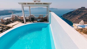 Una piscina en la azotea con vista al mar y a islas distantes.